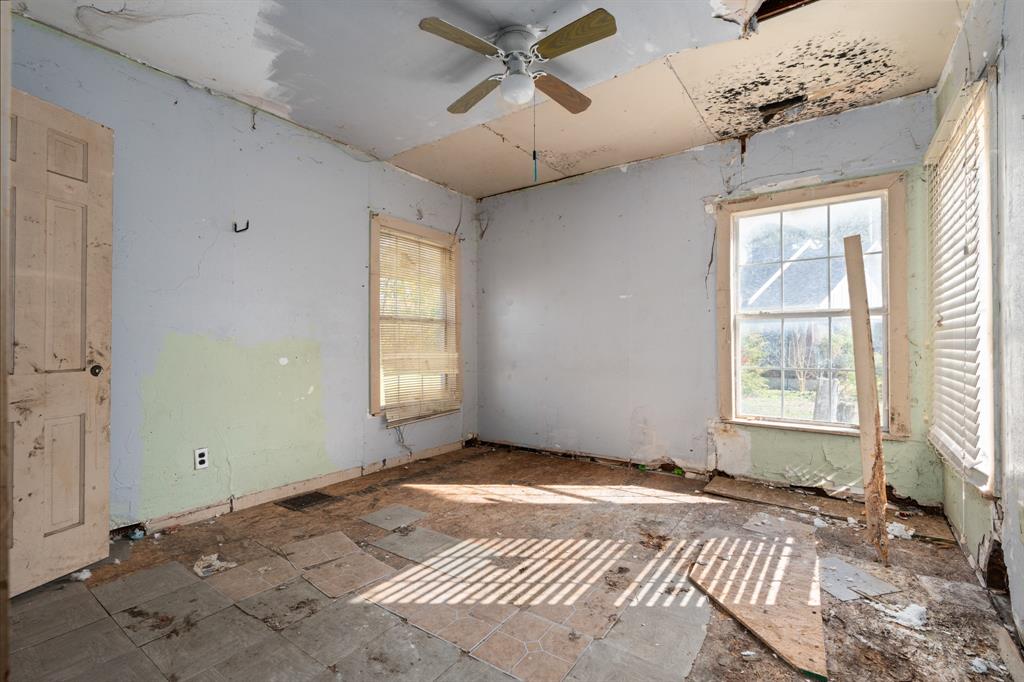 218 North Preston Street Whitney, TX 76692 - Photo 18 of 23 a view of a livingroom with a chandelier fan and windows
