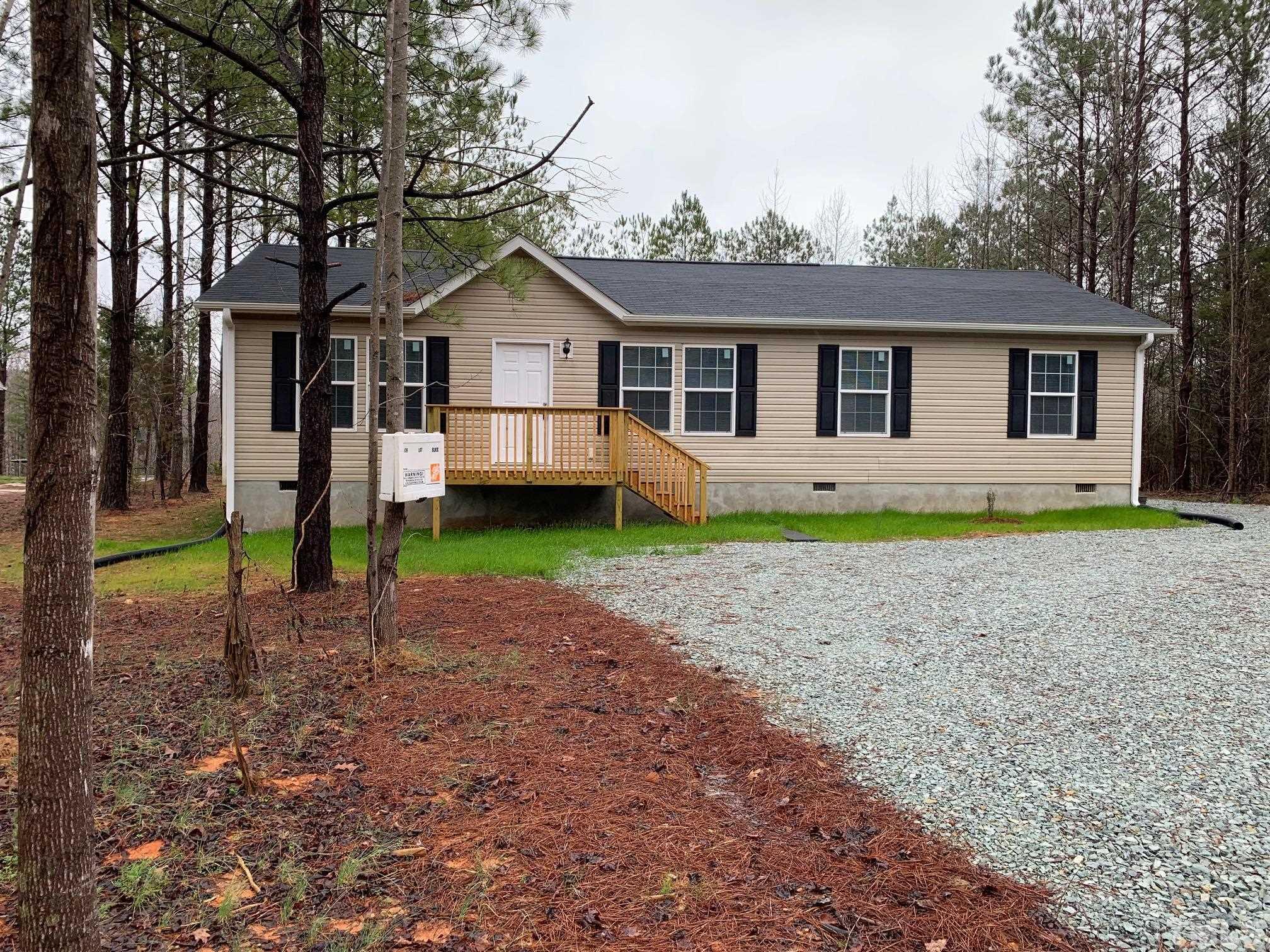 694 Stoney Mountain Road Rougemont, NC 27572 - Photo 1 of 23 a front view of house with a garden