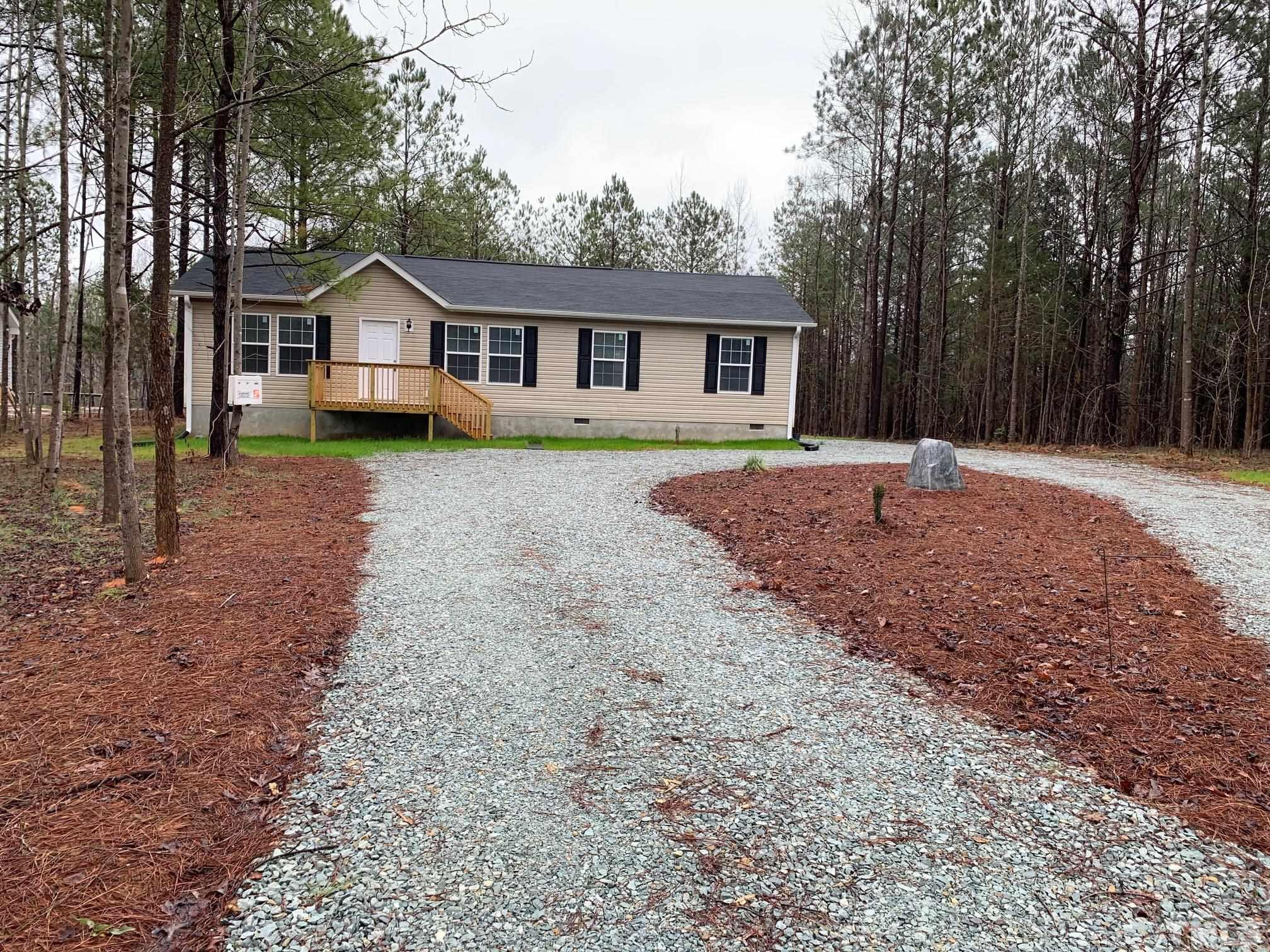 694 Stoney Mountain Road Rougemont, NC 27572 - Photo 2 of 23 a front view of a house with a yard