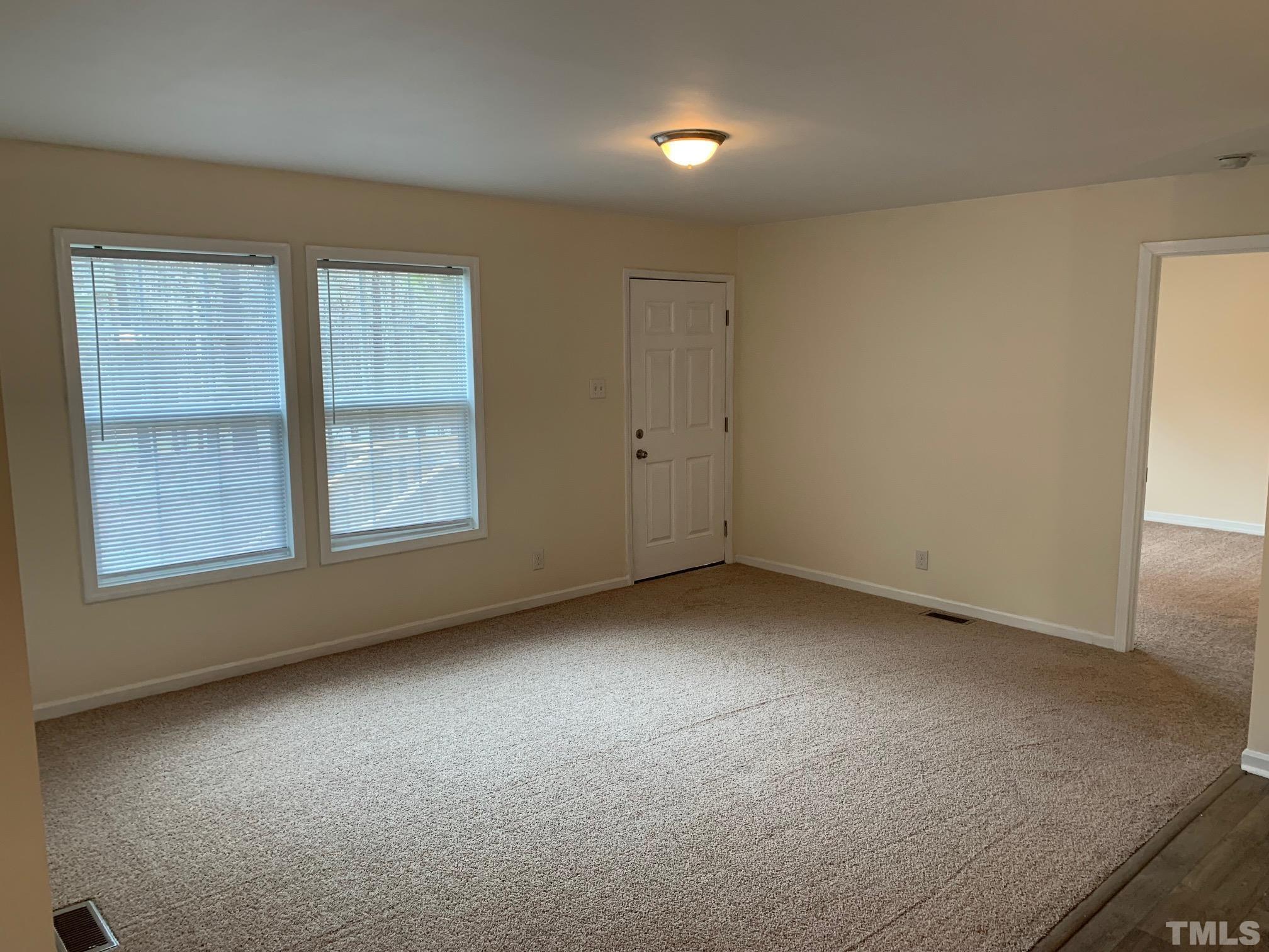 694 Stoney Mountain Road Rougemont, NC 27572 - Photo 3 of 23 an empty room with windows