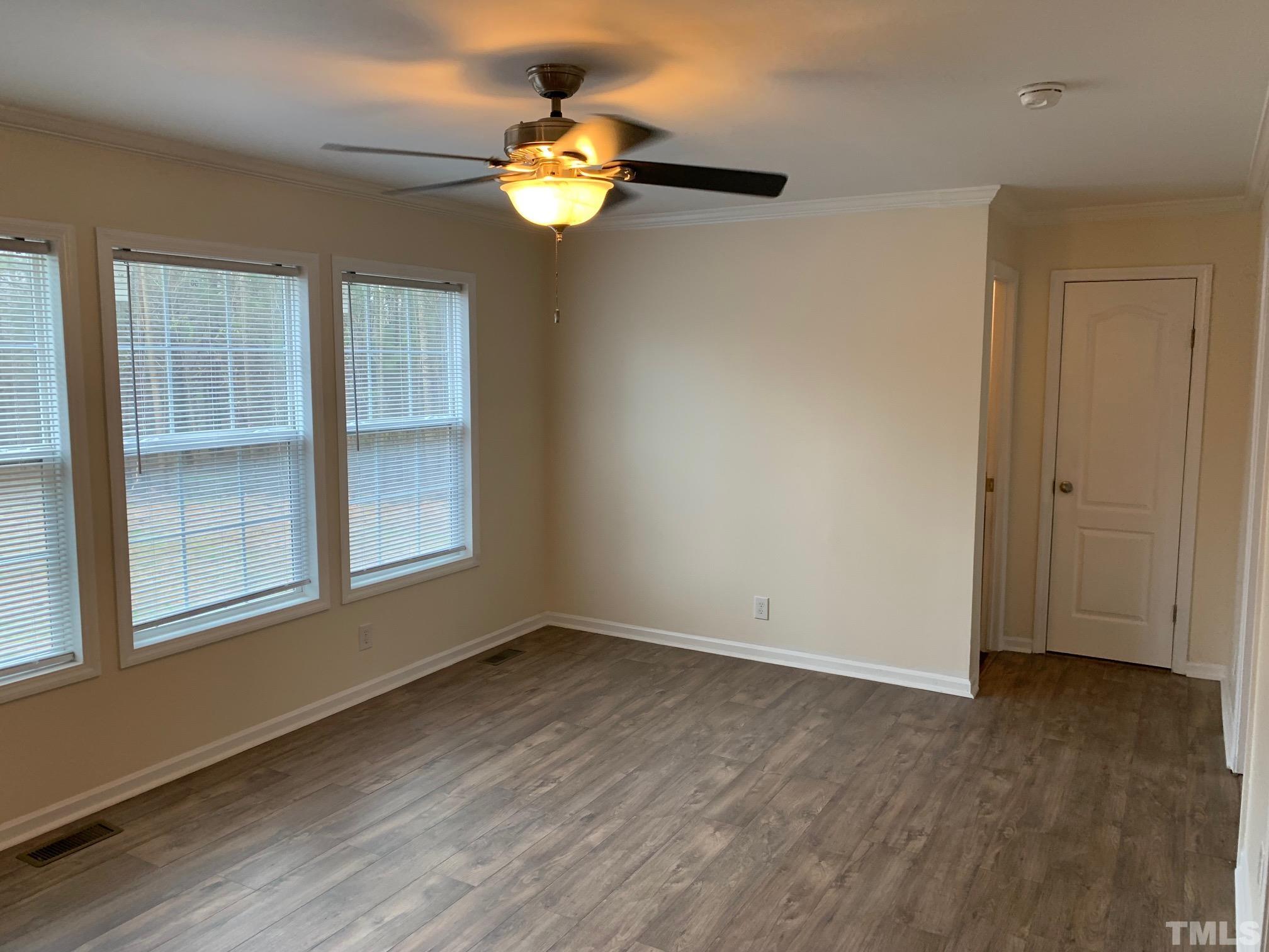694 Stoney Mountain Road Rougemont, NC 27572 - Photo 7 of 23 an empty room with wooden floor and windows