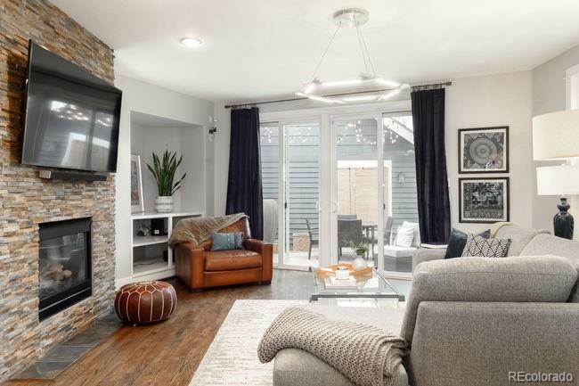 3604 Raleigh Street Denver, CO 80212 - Photo 18 of 38 a living room with furniture a fireplace and a large window