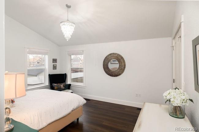3604 Raleigh Street Denver, CO 80212 - Photo 21 of 38 a bedroom with a bed and a chandelier