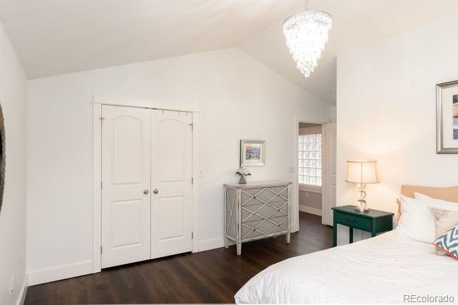 3604 Raleigh Street Denver, CO 80212 - Photo 22 of 38 a bedroom with a bed and a chandelier