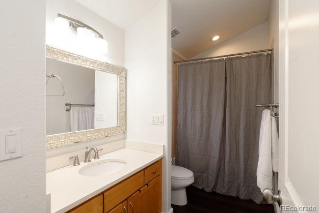 3604 Raleigh Street Denver, CO 80212 - Photo 23 of 38 a bathroom with a sink vanity mirror and toilet