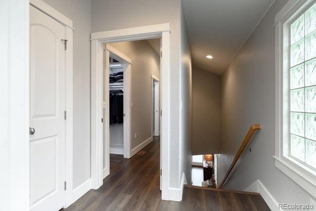 3604 Raleigh Street Denver, CO 80212 - Photo 30 of 38 a view of a hallway with wooden floor and stairs