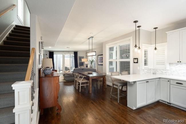 3604 Raleigh Street Denver, CO 80212 - Photo 9 of 38 a open kitchen with stainless steel appliances kitchen island granite countertop a stove and a wooden floors