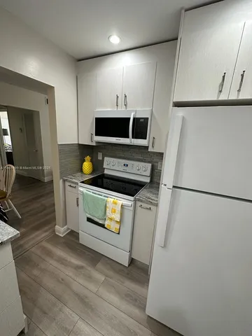 a kitchen with a refrigerator stove and microwave