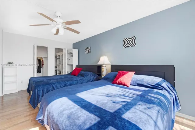 a bedroom with bed and a chandelier