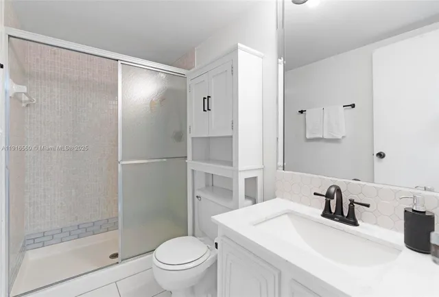 a bathroom with a sink toilet and shower