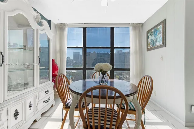 a view of a dining room with furniture a chandelier and wooden floor