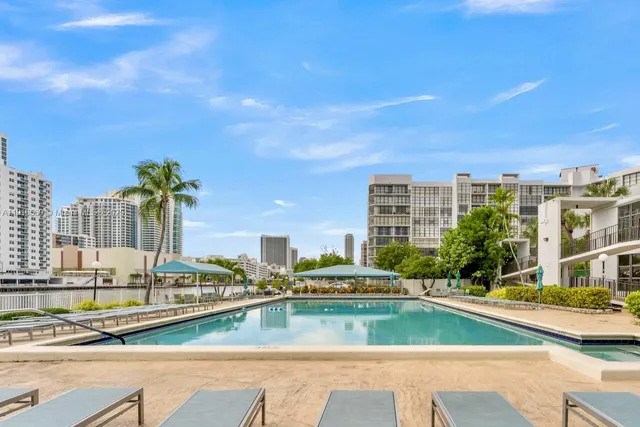a view of swimming pool with outdoor seating and city view