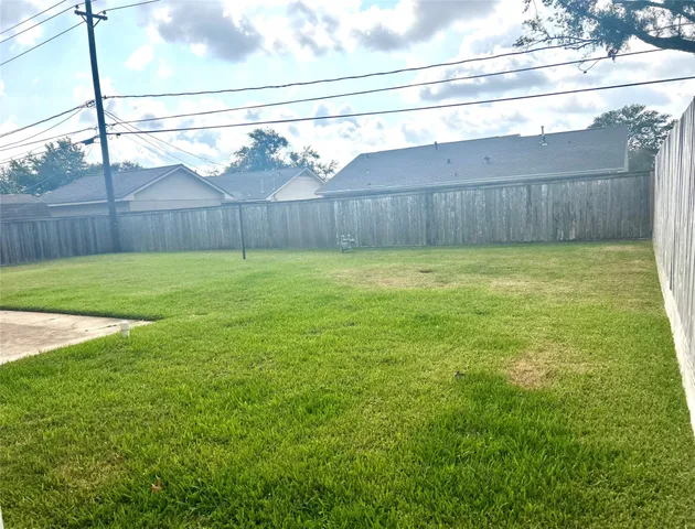 a view of a backyard with a fence