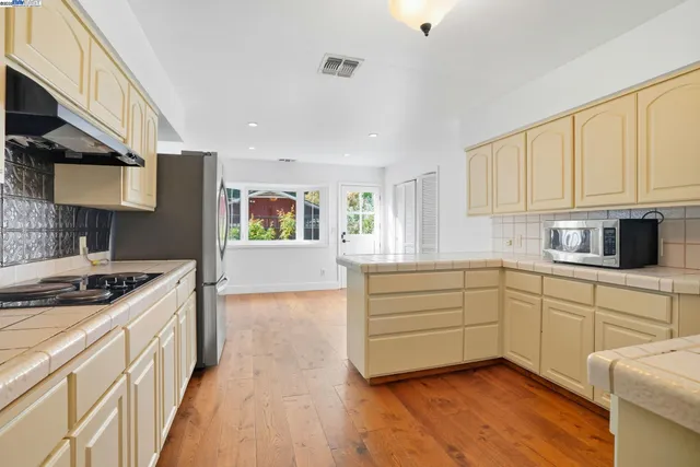 a kitchen with stainless steel appliances granite countertop a refrigerator sink and cabinets