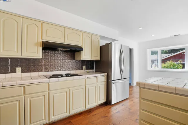 a kitchen with a refrigerator and a sink