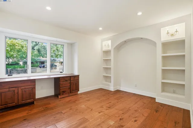 a large bedroom with a bed and a window