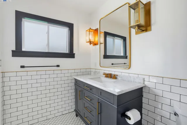a bathroom with a sink and mirror with toilet