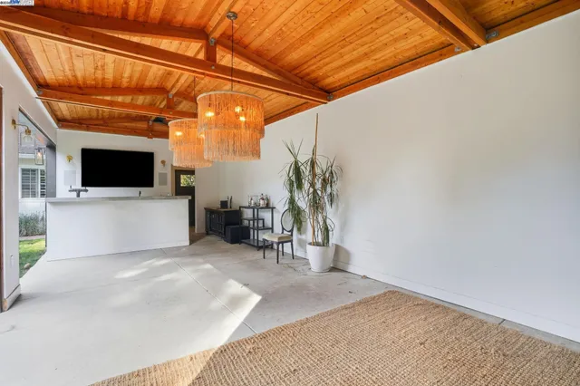a view of a backyard with plants and outdoor seating