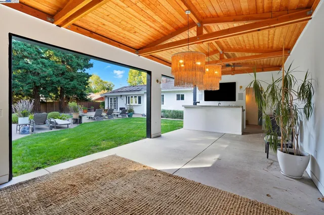 a view of a terrace with a garden and deck