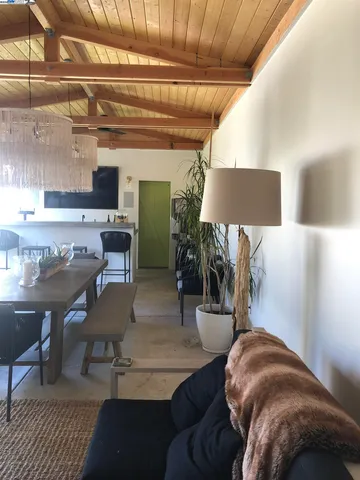 a kitchen with a stove and a view of living room