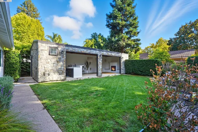a front view of a house with swimming pool having outdoor seating