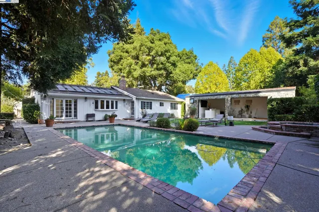 a view of a house with a backyard and a patio
