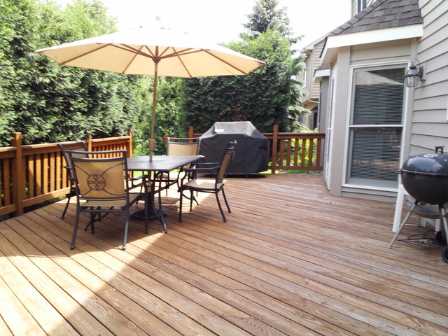 1234 Fagan Road Batavia, IL 60510 - Photo 21 of 25 a view of deck with table and chairs under an umbrella with wooden floor