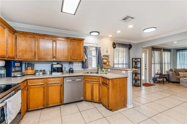 a large kitchen with stainless steel appliances lots of counter top space