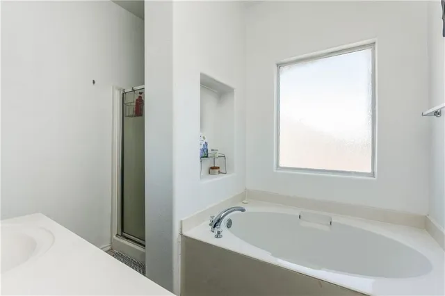 a white bath tub sitting next to a white sink