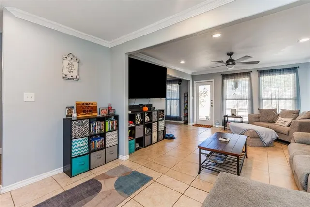 a living room with furniture a window and a flat screen tv