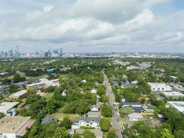an aerial view of residential houses with city view