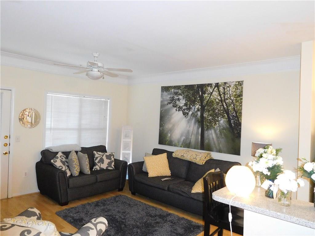2700 Pine Tree Road Northeast, Unit 2115 Atlanta, GA 30324 - Photo 1 of 1 Living Room /Door leads to Small Patio