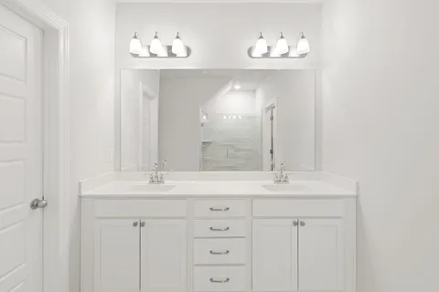 a bathroom with a double vanity sink and a mirror