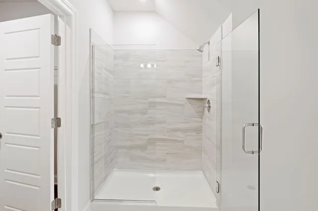 a bathroom with a glass shower door