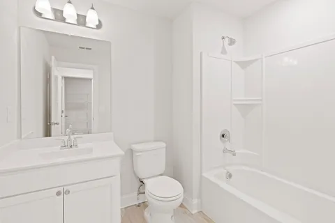 a bathroom with a sink a toilet and a bathtub