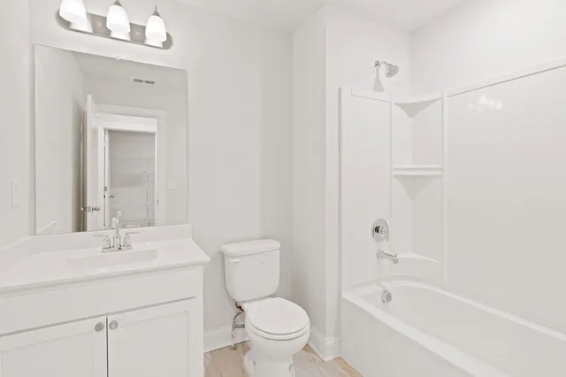 a bathroom with a sink a toilet and a bathtub