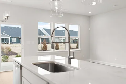 a view of a kitchen with a sink and chandelier