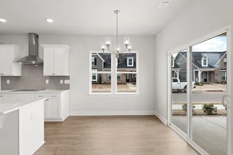 a view of a kitchen with granite countertop a sink and cabinets