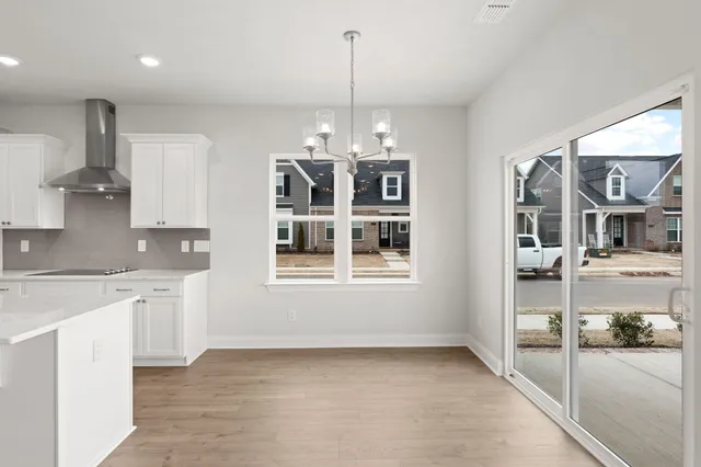a view of a kitchen with granite countertop a sink and cabinets