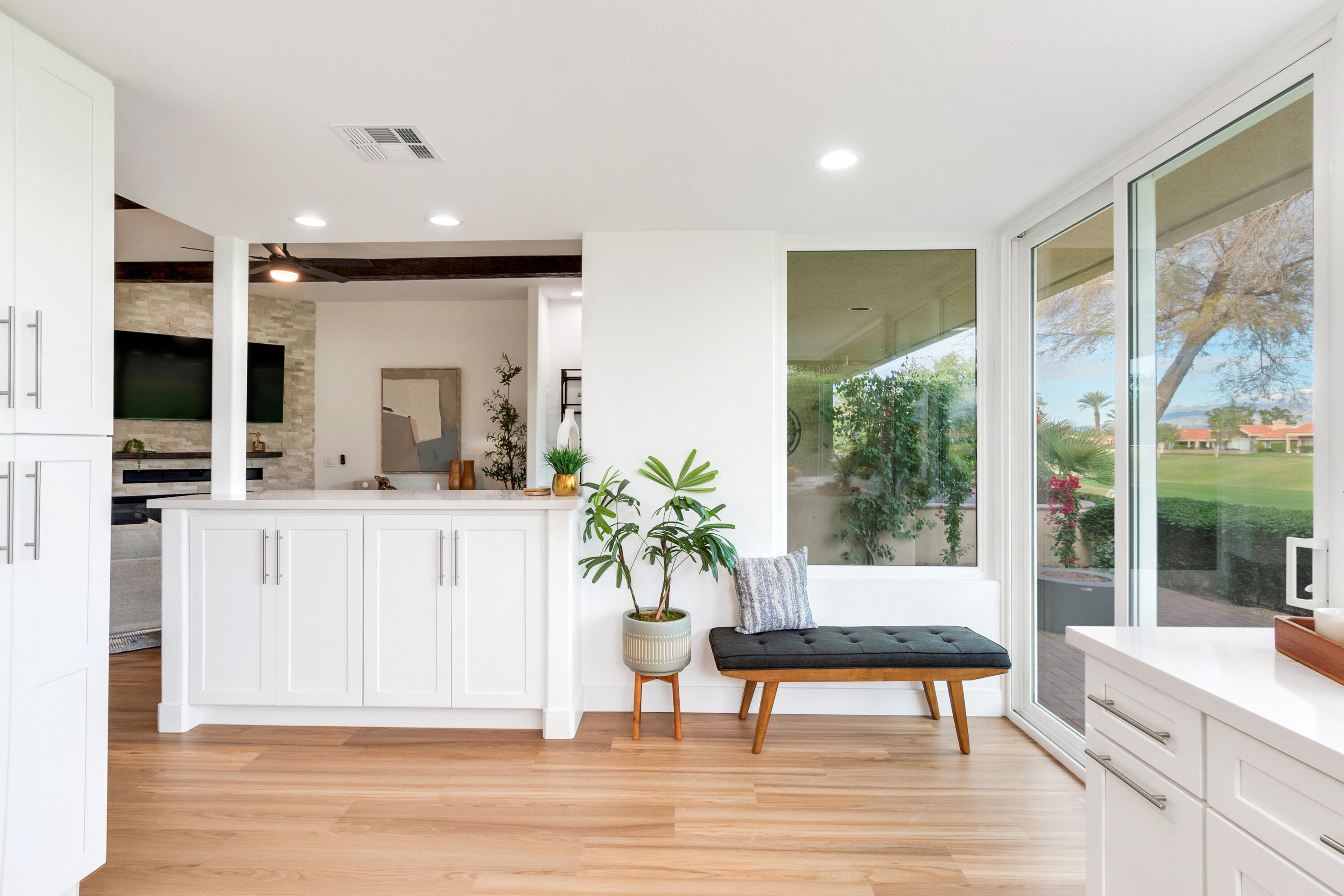 30 Hilton Head Drive Rancho Mirage, CA 92270 - Photo 12 of 33 a living room with furniture a flat screen tv and a floor to ceiling window