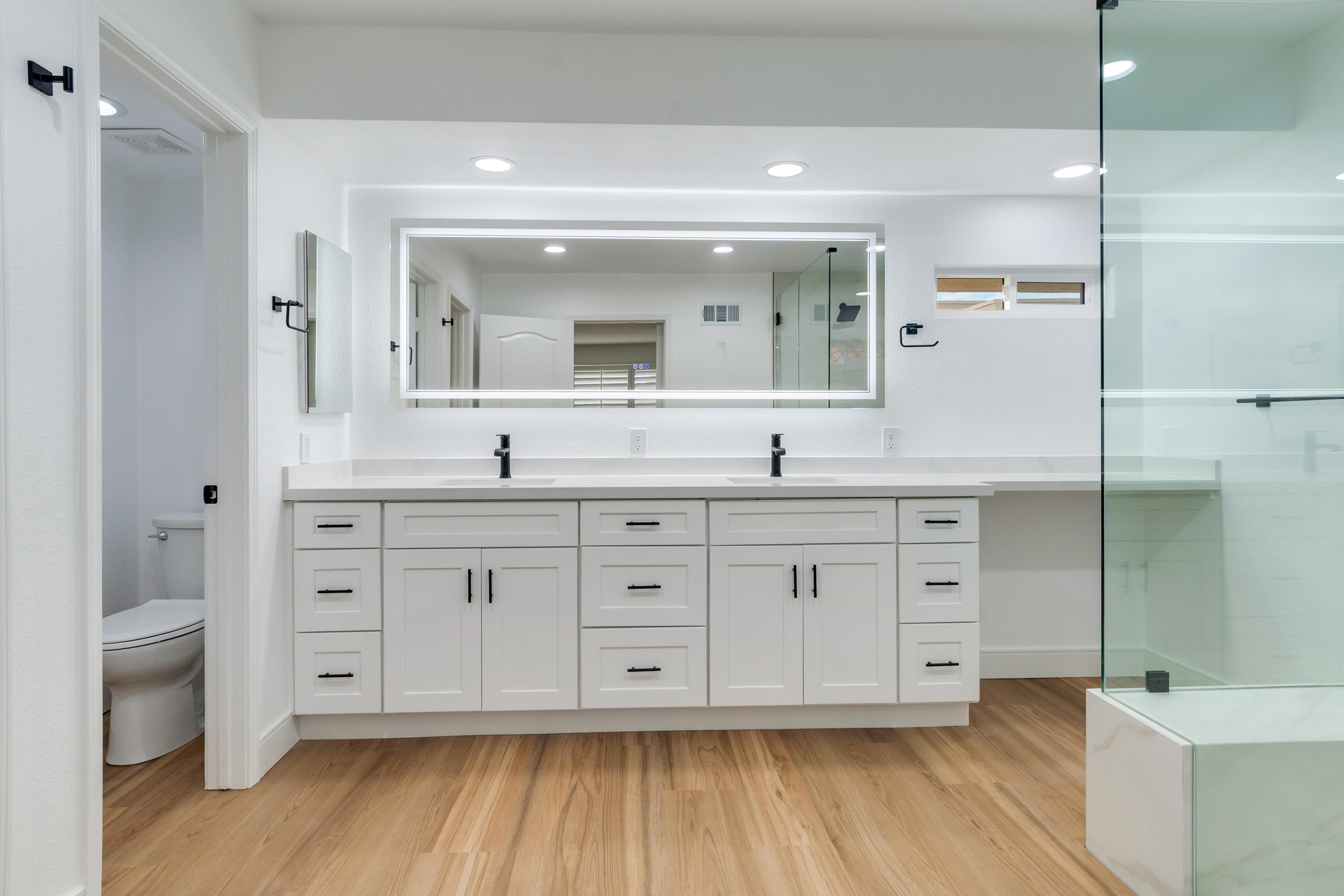 30 Hilton Head Drive Rancho Mirage, CA 92270 - Photo 19 of 33 a bathroom with a granite countertop double vanity sink a mirror and a toilet