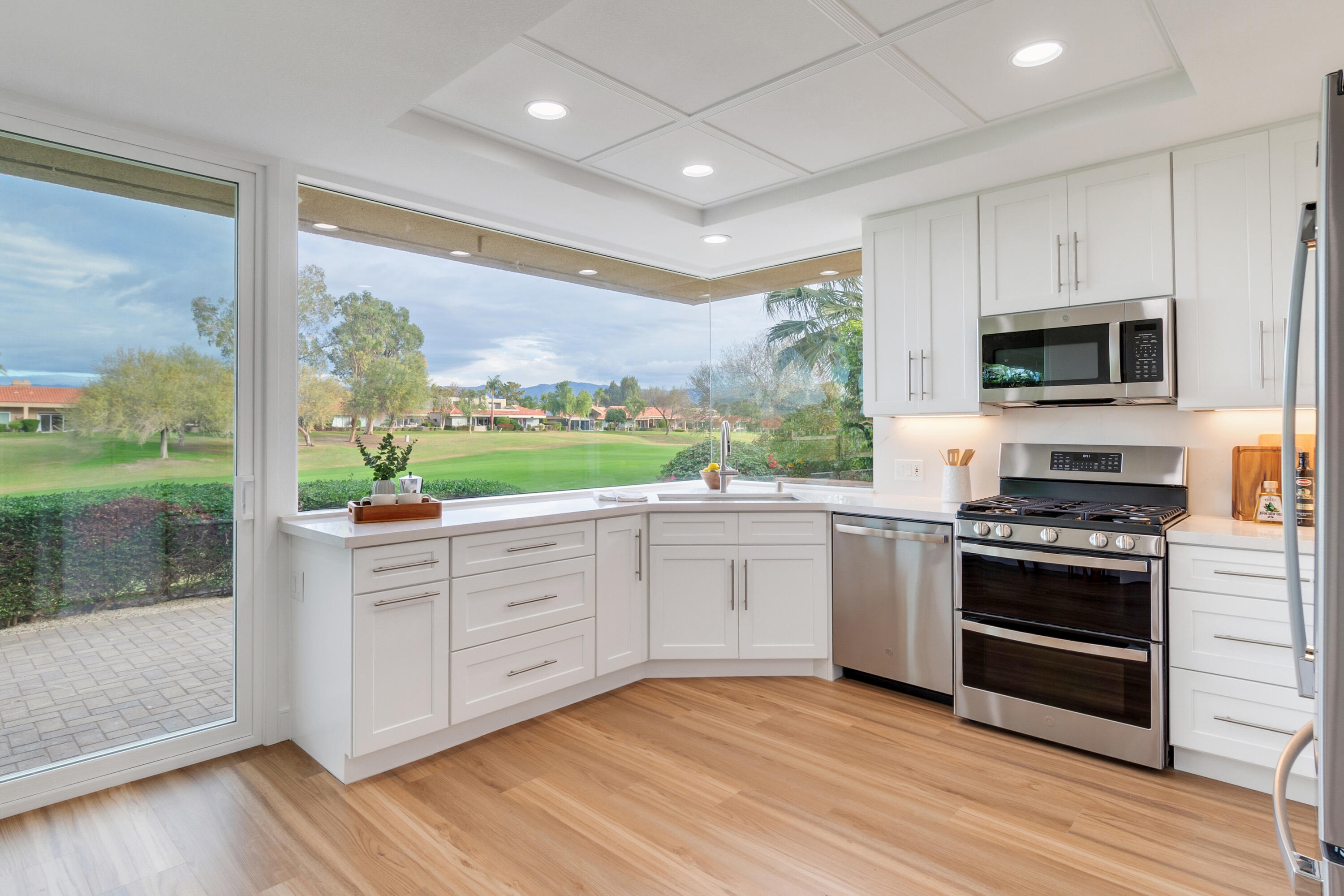 30 Hilton Head Drive Rancho Mirage, CA 92270 - Photo 3 of 33 a kitchen with stainless steel appliances granite countertop a stove a sink and a microwave