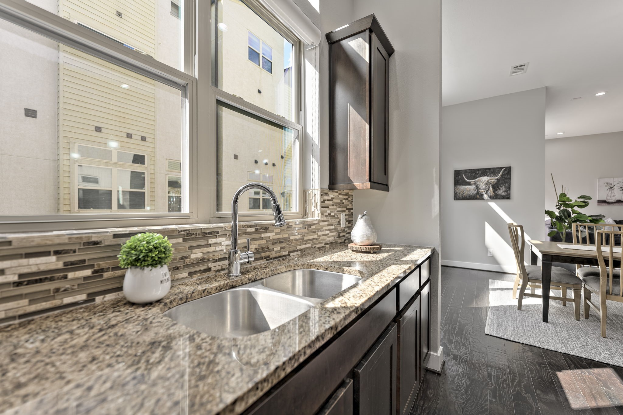 4408 Eli Street, Unit C Houston, TX 77007 - Photo 12 of 48 a kitchen with a granite countertop sink a potted plant and a large window