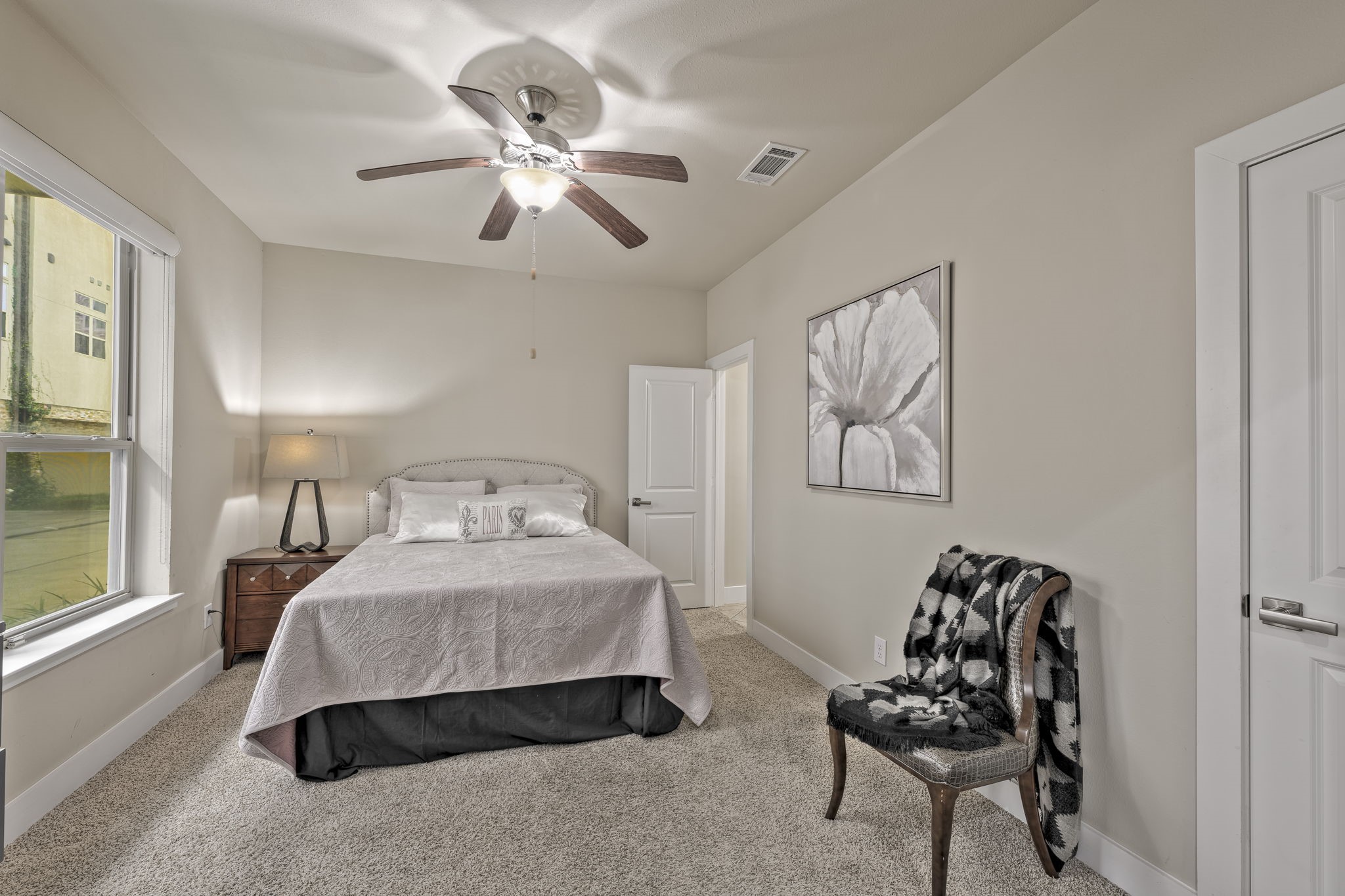 4408 Eli Street, Unit C Houston, TX 77007 - Photo 3 of 48 a bedroom with a bed and a chandelier