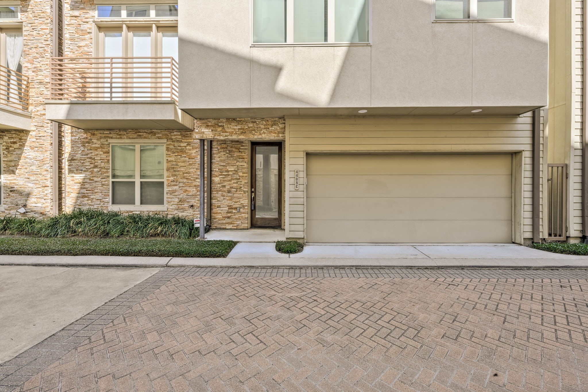 4408 Eli Street, Unit C Houston, TX 77007 - Photo 44 of 48 a front view of a house with a yard and a garage