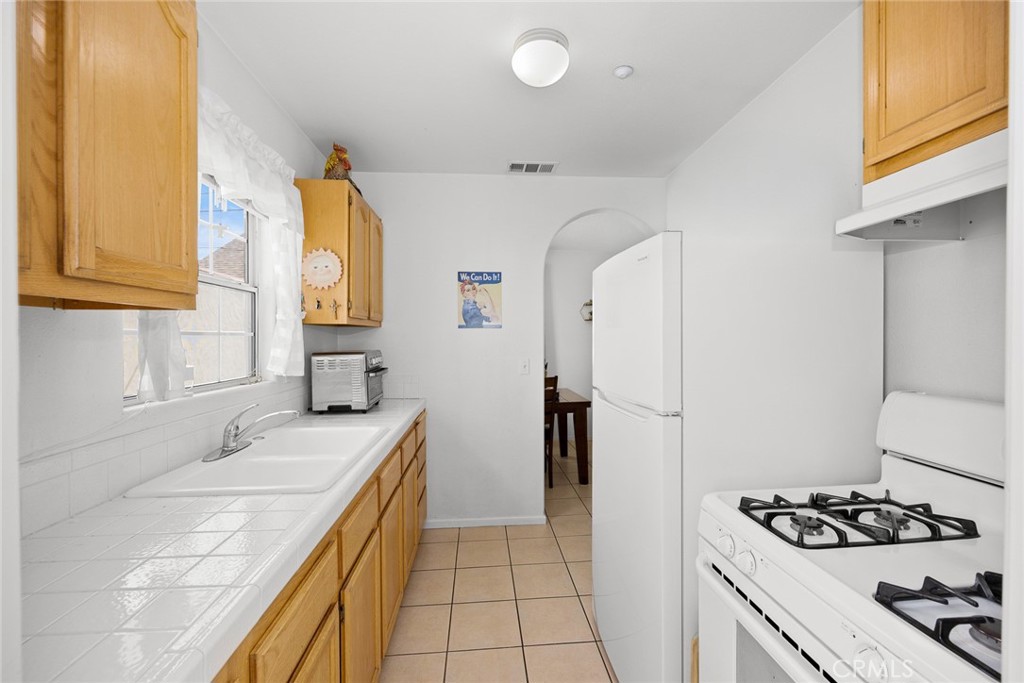 2306 Alhambra Road Alhambra, CA 91801 - Photo 17 of 29 a kitchen with a sink a refrigerator a stove and a window