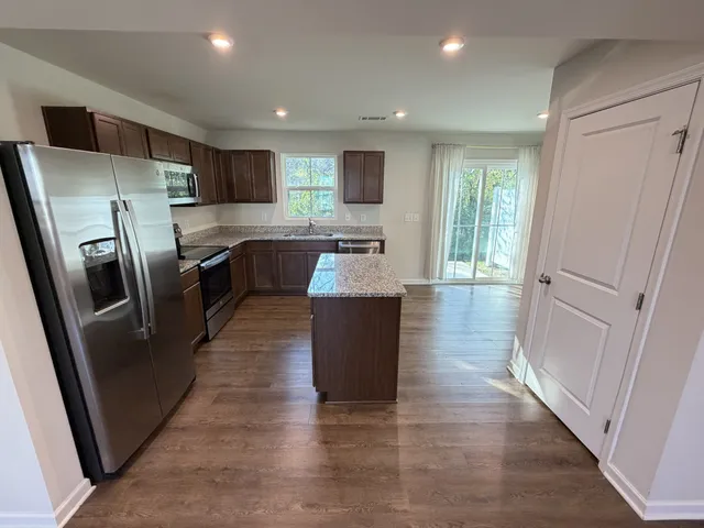 a kitchen with a refrigerator stove and microwave