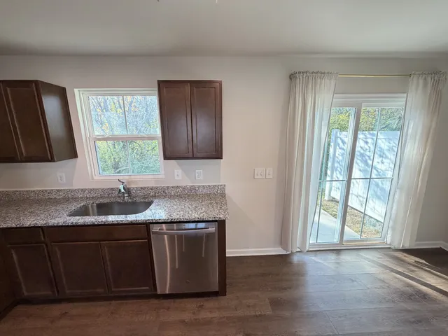 a living room with a stove and a wooden floor