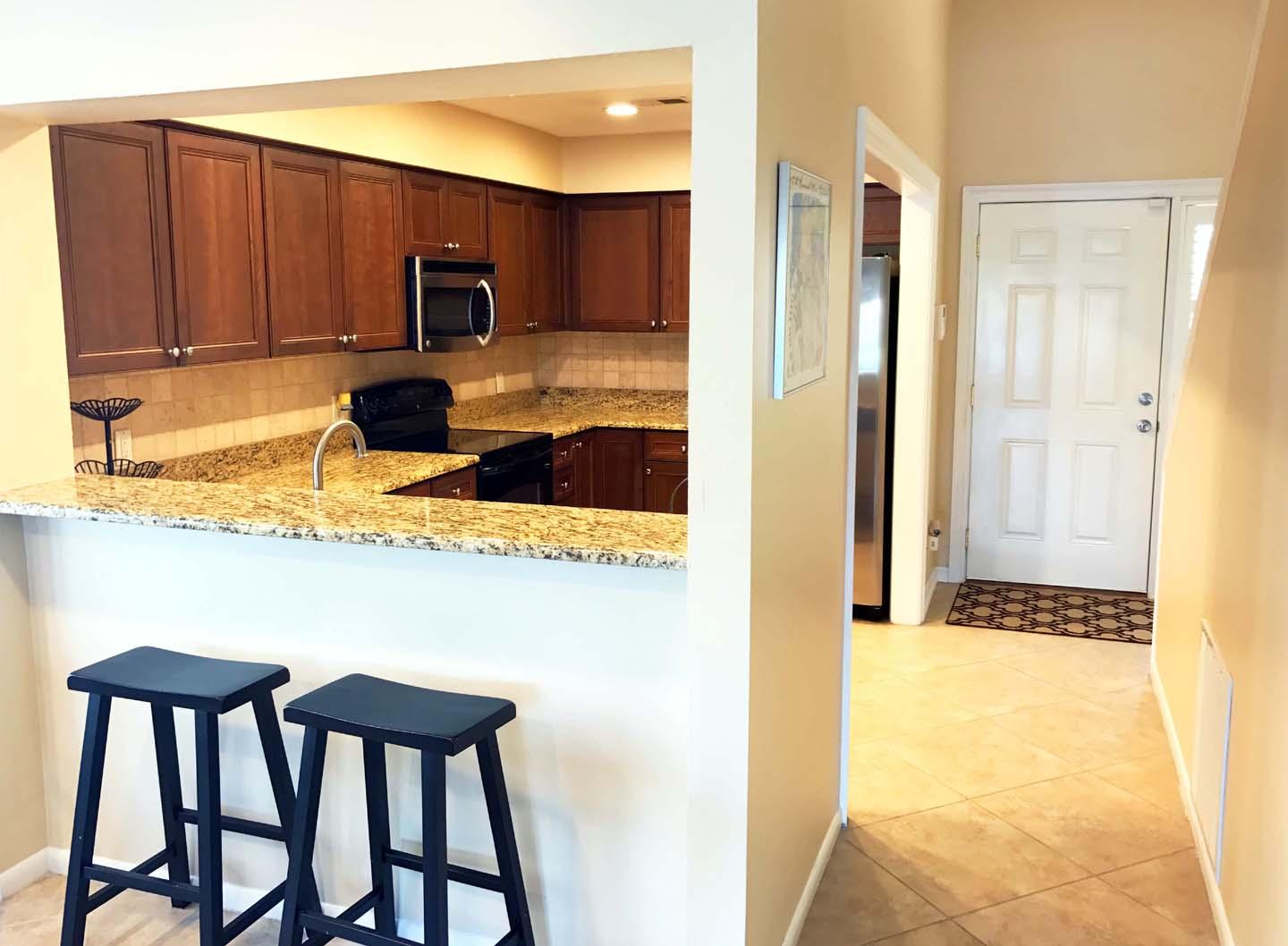 5073 Beachwalk Way Miramar Beach, FL 32550 - Photo 12 of 61 a kitchen with a refrigerator a stove and a cabinets