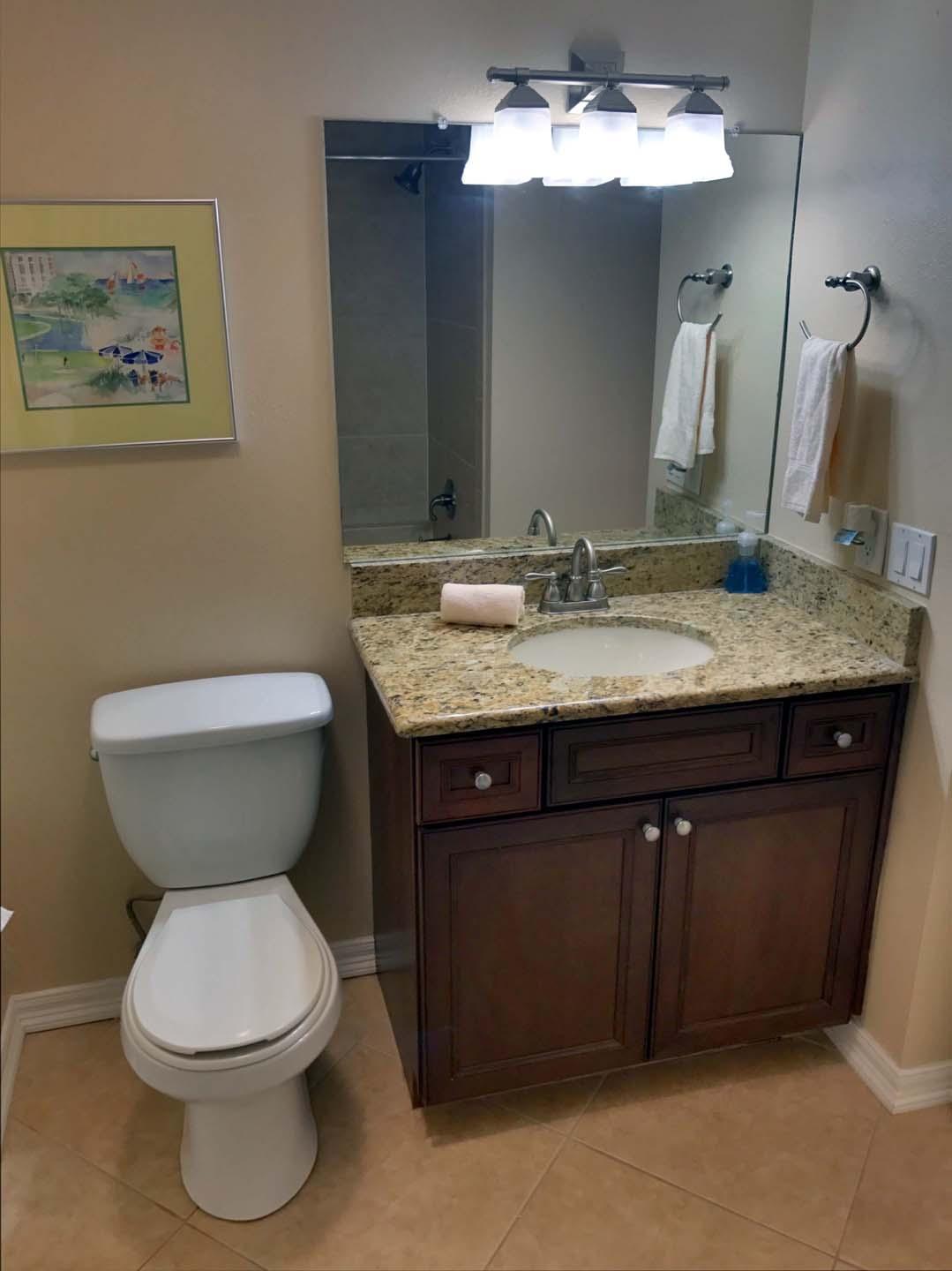 5073 Beachwalk Way Miramar Beach, FL 32550 - Photo 26 of 61 a bathroom with a granite countertop toilet sink and mirror
